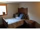 Cozy bedroom featuring a bed with decorative pillows and a side table at 933 Skeel St, Brighton, CO 80601