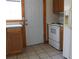 Well-lit kitchen featuring tiled floor and essential appliances at 933 Skeel St, Brighton, CO 80601