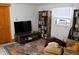 Inviting living room with television, book shelves and area rug at 933 Skeel St, Brighton, CO 80601