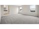 A spacious carpeted bedroom with two large windows at 16633 W 93Rd Way, Arvada, CO 80007