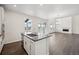 Open kitchen with hardwood floors, stainless steel appliances, and lots of natural light at 16633 W 93Rd Way, Arvada, CO 80007