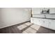 Bright kitchen area featuring white cabinets, dark countertops, stainless steel microwave, and modern finishes at 16633 W 93Rd Way, Arvada, CO 80007