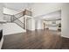 Open-concept living area with modern floors and kitchen featuring stainless steel appliances and large island at 16633 W 93Rd Way, Arvada, CO 80007