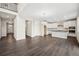 Open-concept living area with modern floors and kitchen featuring stainless steel appliances at 16633 W 93Rd Way, Arvada, CO 80007