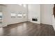 Living room showcasing tall windows, fireplace, modern floors, and plenty of natural light at 16633 W 93Rd Way, Arvada, CO 80007