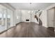 Bright living room featuring hardwood floors, a fireplace, chandelier, and staircase at 16633 W 93Rd Way, Arvada, CO 80007