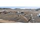 Wide aerial view of the property surrounded by undeveloped land, showcasing the home's secluded location at 12990 Mesa View Rd, Larkspur, CO 80118