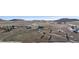 Panoramic aerial view of a two-story home and outbuildings on a vast, rural landscape at 12990 Mesa View Rd, Larkspur, CO 80118