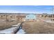 Aerial view of the two-story home, with a brick and siding exterior, on expansive land at 12990 Mesa View Rd, Larkspur, CO 80118