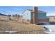 Back exterior view of the two-story home with fenced-in yard and patio at 12990 Mesa View Rd, Larkspur, CO 80118
