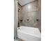 Modern bathroom with tiled shower, shelves, and neutral fixtures at 12990 Mesa View Rd, Larkspur, CO 80118