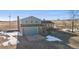 Charming two-story home in a rural setting, featuring a blue garage door and brick accents at 12990 Mesa View Rd, Larkspur, CO 80118