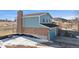Charming two-story home with brick and siding exterior, attached garage, and chimney at 12990 Mesa View Rd, Larkspur, CO 80118