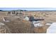 This aerial showcases a well-maintained home, highlighting its architectural style and setting on a large lot at 12990 Mesa View Rd, Larkspur, CO 80118