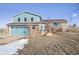 Charming two-story home with brick and siding exterior and an attached garage at 12990 Mesa View Rd, Larkspur, CO 80118