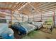 Spacious garage or barn interior with multiple cars and visible wooden beams at 12990 Mesa View Rd, Larkspur, CO 80118