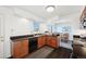 Well-equipped kitchen with wood cabinets, sleek countertops, and a view of the dining area, great for cooking at 12990 Mesa View Rd, Larkspur, CO 80118