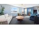 Cozy living room featuring a large window, neutral walls, and comfortable seating, creating a welcoming space at 12990 Mesa View Rd, Larkspur, CO 80118