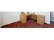 Office area with wooden desk and plenty of storage space on a red carpet at 12990 Mesa View Rd, Larkspur, CO 80118