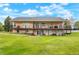 Large backyard featuring a multi-tiered deck, lush lawn, and landscaping perfect for outdoor living at 34682 Stampede Cir, Elizabeth, CO 80107