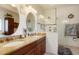 The bathroom features a granite double vanity, a large mirror, and glass shower at 34682 Stampede Cir, Elizabeth, CO 80107