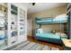 Comfortable bedroom features a bunk bed, built in shelving, and hardwood floors at 34682 Stampede Cir, Elizabeth, CO 80107
