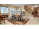 Bright dining area features stairs to the upper level, an outside entrance, and storage shelves at 34682 Stampede Cir, Elizabeth, CO 80107