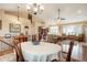 Bright and airy dining room, showcasing hardwood floors and a view of the living room at 34682 Stampede Cir, Elizabeth, CO 80107