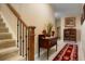 Inviting foyer with staircase, table decor, and stylish rug enhancing the home's character at 34682 Stampede Cir, Elizabeth, CO 80107
