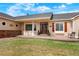 Inviting home entrance with front porch, decorative elements, and manicured lawn and front garden at 34682 Stampede Cir, Elizabeth, CO 80107