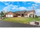 Beautiful single-story home featuring an attached three-car garage, well-maintained lawn, and meticulous landscaping at 34682 Stampede Cir, Elizabeth, CO 80107