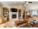 Inviting living room with a cozy fireplace, built-in shelving, and views to the dining area at 34682 Stampede Cir, Elizabeth, CO 80107