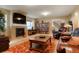Inviting living room features a fireplace, comfortable seating, and built-in bookshelves at 34682 Stampede Cir, Elizabeth, CO 80107