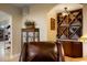 Elegant living room features a wine rack, display cabinet, and comfortable seating at 34682 Stampede Cir, Elizabeth, CO 80107