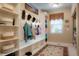 Mudroom with built in bench, coat hooks, shelving and large window at 34682 Stampede Cir, Elizabeth, CO 80107