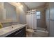 Nicely tiled bathroom with shower-tub combination, vanity, and toilet at 3327 Irving St, Denver, CO 80211
