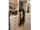 Walk-in closet featuring built-in shelving, drawers, and a mirrored door for organized storage at 3327 Irving St, Denver, CO 80211