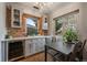 Inviting dining area with natural light, custom cabinets and a wine cooler at 3327 Irving St, Denver, CO 80211