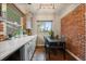 Cozy dining area with exposed brick, table, and natural light at 3327 Irving St, Denver, CO 80211