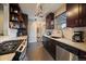 Bright kitchen featuring granite counters, stainless appliances, and dark wood cabinets at 3327 Irving St, Denver, CO 80211