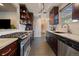Modern kitchen with dark wood cabinets, stainless steel appliances, and granite countertops at 3327 Irving St, Denver, CO 80211