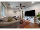 Cozy living room featuring hardwood floors, a ceiling fan, and comfortable seating at 3327 Irving St, Denver, CO 80211
