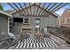 Cozy patio featuring a pergola with hanging lights and comfortable seating for relaxing outdoors at 3327 Irving St, Denver, CO 80211