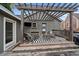 Inviting patio area with pergola, outdoor seating, and a small shed, perfect for outdoor gatherings at 3327 Irving St, Denver, CO 80211
