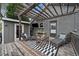 Charming backyard patio area featuring a pergola with string lights and comfortable seating arrangement at 3327 Irving St, Denver, CO 80211