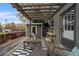 Inviting outdoor patio with pergola, string lights, and stylish furniture for relaxing and entertaining at 3327 Irving St, Denver, CO 80211