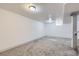 The large basement has gray carpet, white walls, and recessed lighting at 3385 Olive St, Denver, CO 80207