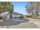 Well-kept home with a gravel yard, charming blue door and a fenced yard at 3385 Olive St, Denver, CO 80207