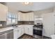 Well-lit kitchen with stainless steel appliances, white cabinets, and a clean, modern design at 3385 Olive St, Denver, CO 80207