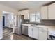 Modern kitchen featuring stainless steel appliances, white cabinets, and sleek countertops at 3385 Olive St, Denver, CO 80207